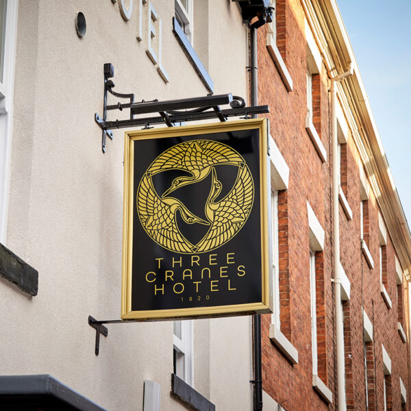 An image of the sign post of Three Cranes Hotel